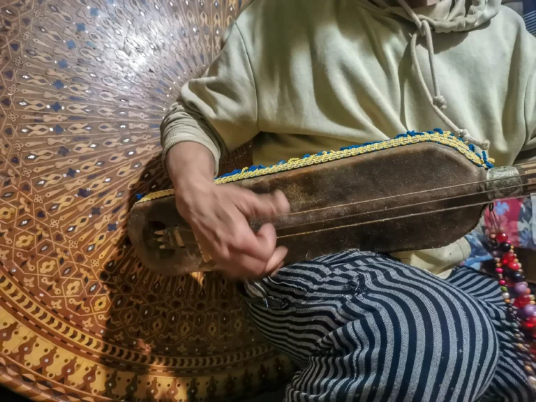 gnawa musician playing music in morocco