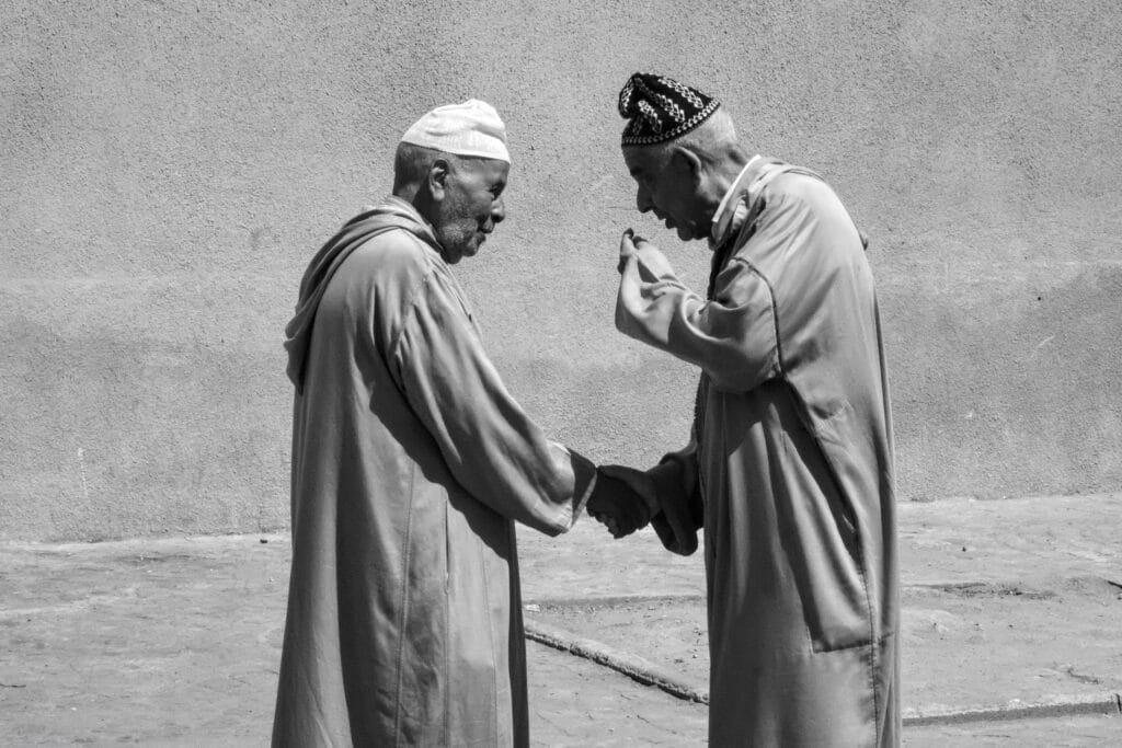 Two man speaking and wearing traditional moroccan clothes in the streets of Essaouira