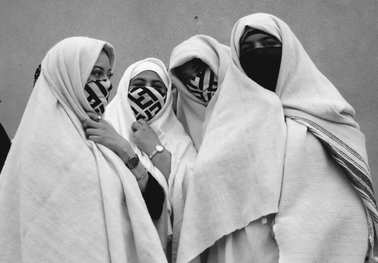 A group of four Moroccan women with traditional clothes in Essaouira's street