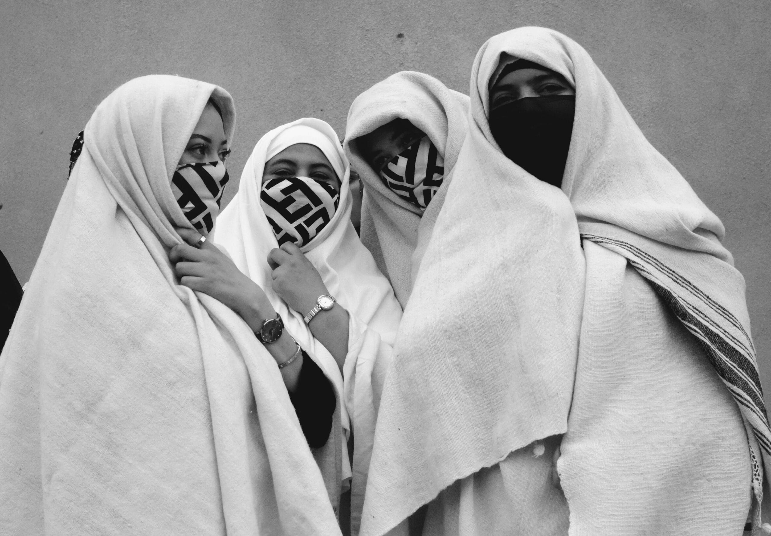 A group of four Moroccan women with traditional clothes in Essaouira's street