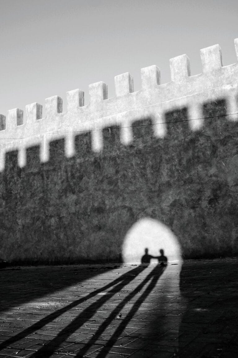Shadows of people on Essaouira city walls