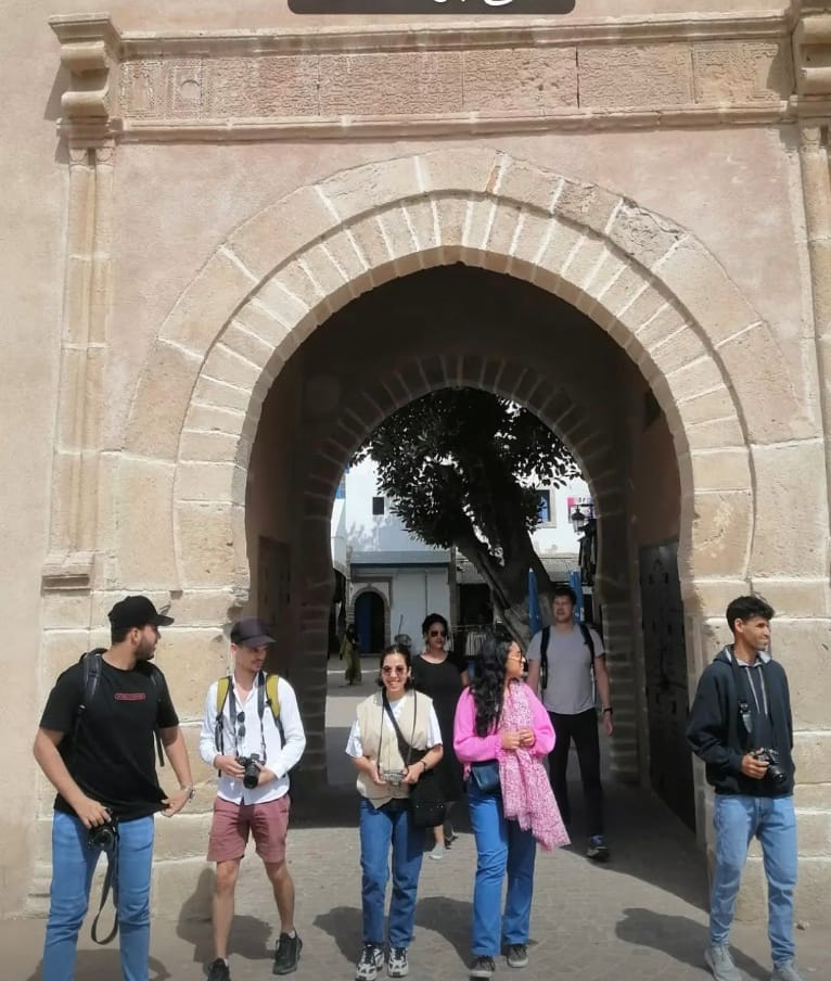Small group of tourists taking pictures during a street photography guided tour in Essaouira