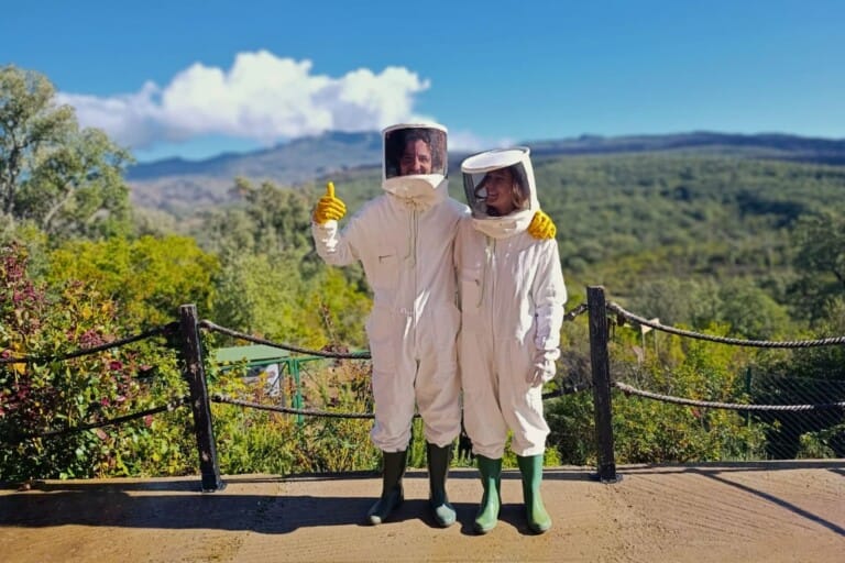 two people wearing beekeper's suits