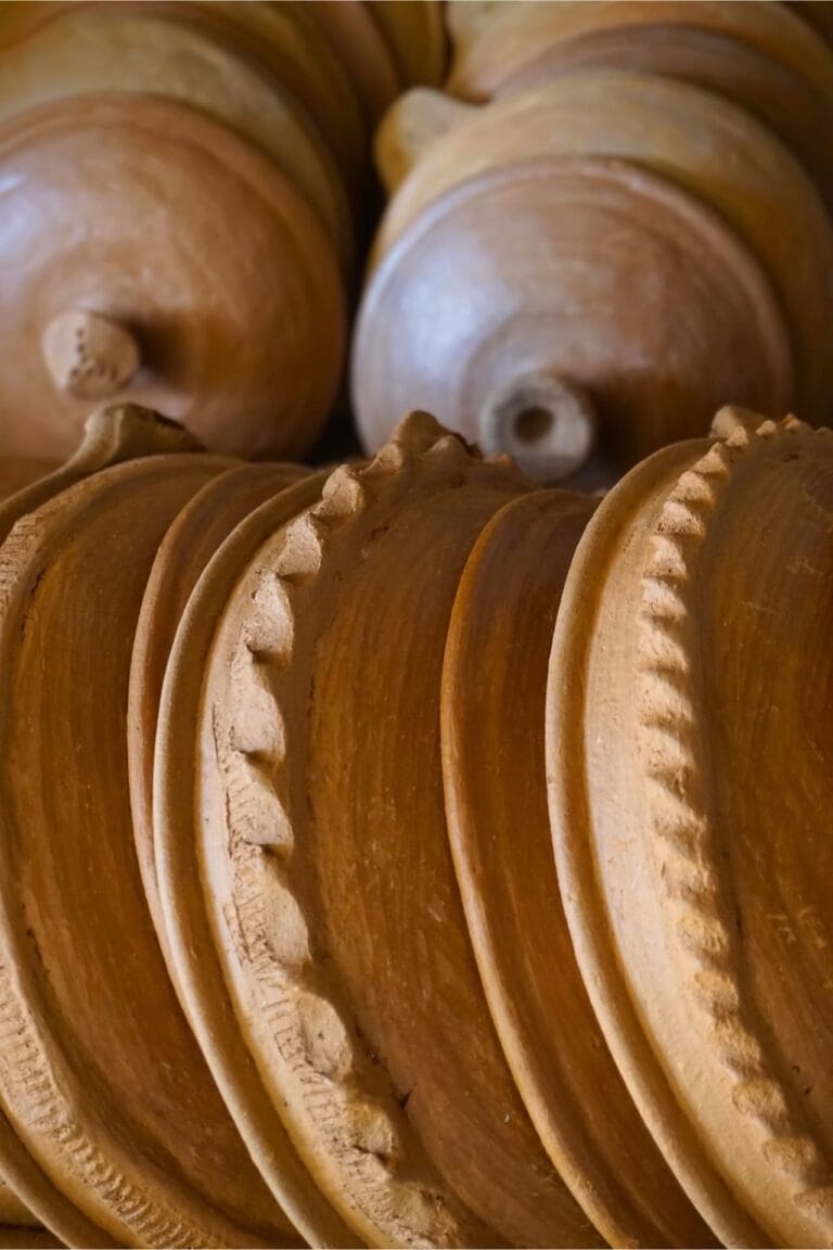 Close-up detail of the decorative scalloped edge on traditional Moroccan tagine lids.