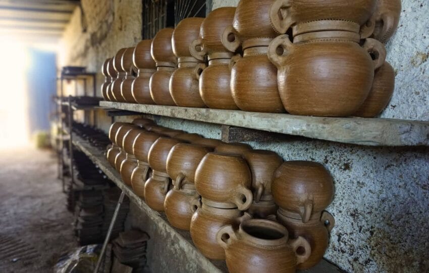 Shelves filled with finished, handcrafted terracotta pottery in a Moroccan workshop.